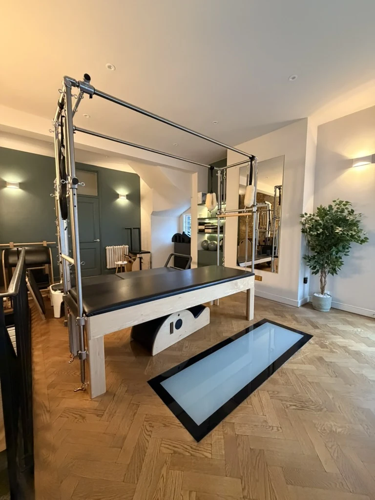 The upstairs FORMe Health Pilates studio with its Cadillac and oak flooring